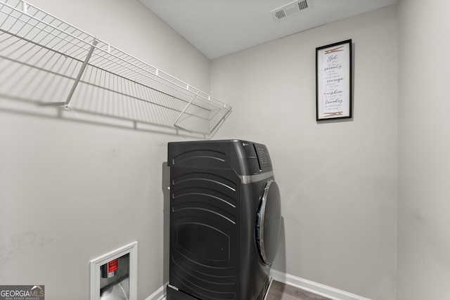 washroom with washer / dryer, laundry area, visible vents, and baseboards