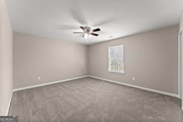 empty room with a ceiling fan, baseboards, visible vents, and carpet flooring