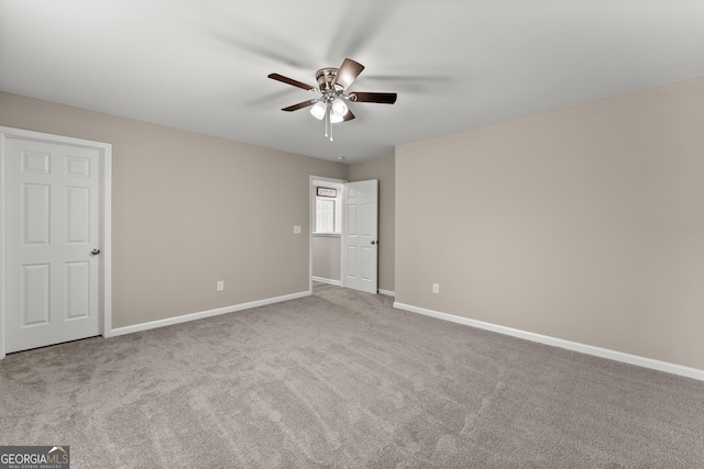 unfurnished bedroom with light carpet, ceiling fan, and baseboards