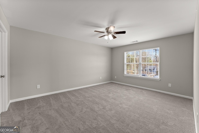 empty room featuring carpet, visible vents, ceiling fan, and baseboards