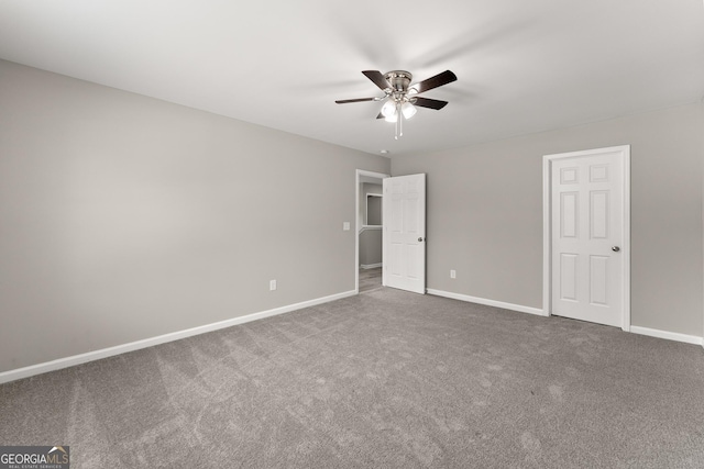 unfurnished bedroom with ceiling fan, baseboards, and carpet flooring