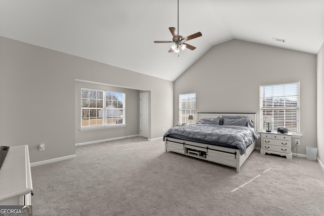 bedroom featuring light carpet, high vaulted ceiling, multiple windows, and baseboards