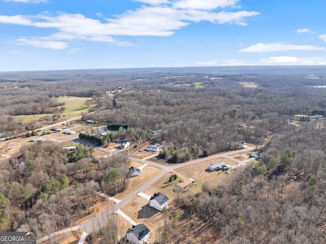 birds eye view of property featuring a forest view