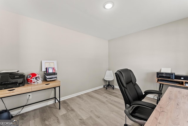 office with light wood-type flooring and baseboards