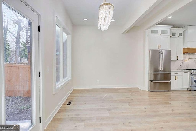 unfurnished dining area with a chandelier, recessed lighting, visible vents, baseboards, and light wood-type flooring