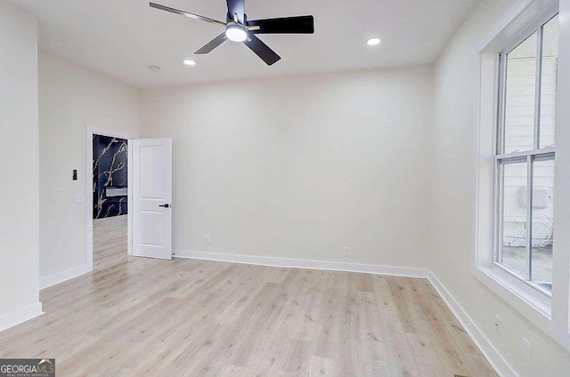 empty room featuring a ceiling fan, recessed lighting, light wood-style flooring, and baseboards