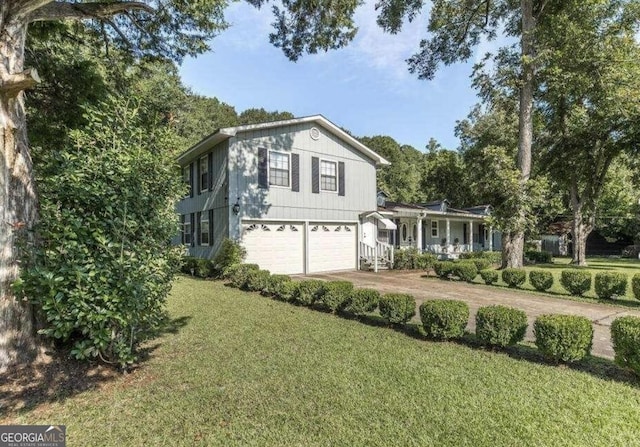 view of front of property with a garage, driveway, and a front yard