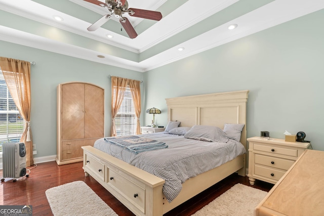 bedroom featuring recessed lighting, dark wood-style flooring, baseboards, ornamental molding, and a raised ceiling