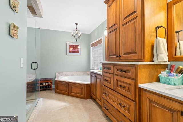 full bathroom with a garden tub, a notable chandelier, a stall shower, vanity, and tile patterned flooring