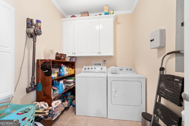 washroom featuring ornamental molding, cabinet space, washer and clothes dryer, and light tile patterned floors