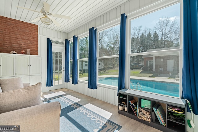 sunroom featuring ceiling fan