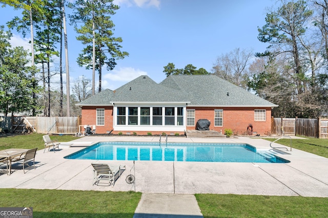 view of pool with a yard, a fenced backyard, a fenced in pool, and a patio