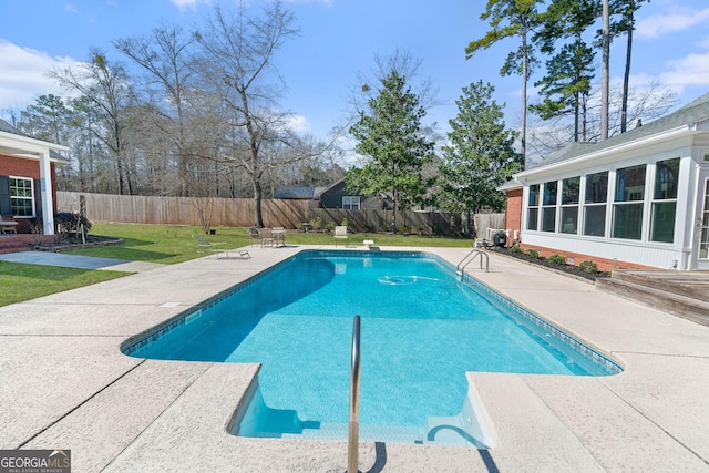 view of swimming pool featuring a fenced in pool, a patio area, a fenced backyard, and a yard