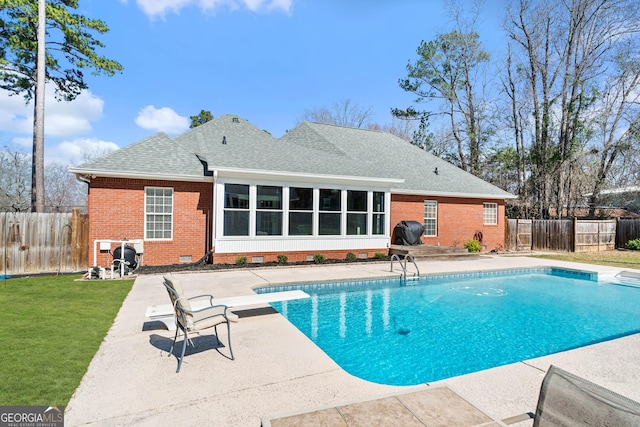 view of pool with a patio, a fenced backyard, area for grilling, a lawn, and a fenced in pool