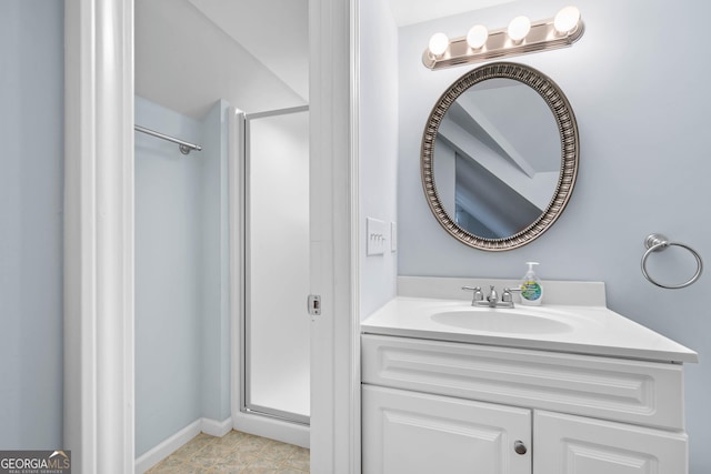 bathroom featuring a stall shower and vanity