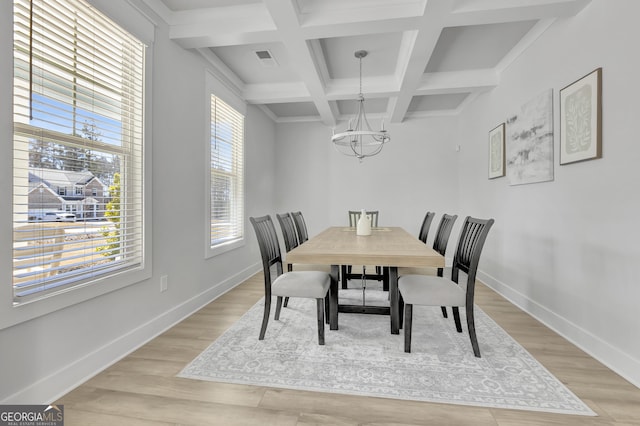 dining room with baseboards, light wood finished floors, and an inviting chandelier