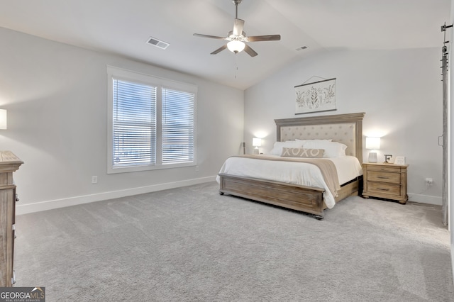 bedroom with lofted ceiling, baseboards, visible vents, and light colored carpet