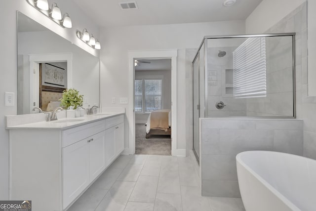 bathroom featuring a stall shower, visible vents, ensuite bathroom, a freestanding tub, and a sink