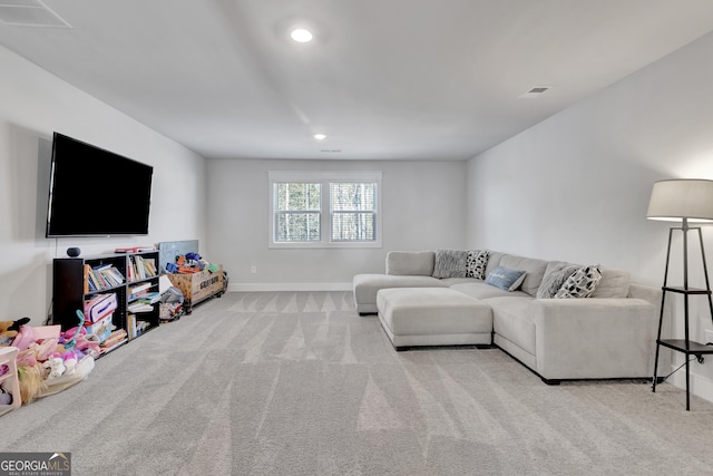 living room with baseboards, recessed lighting, visible vents, and light colored carpet