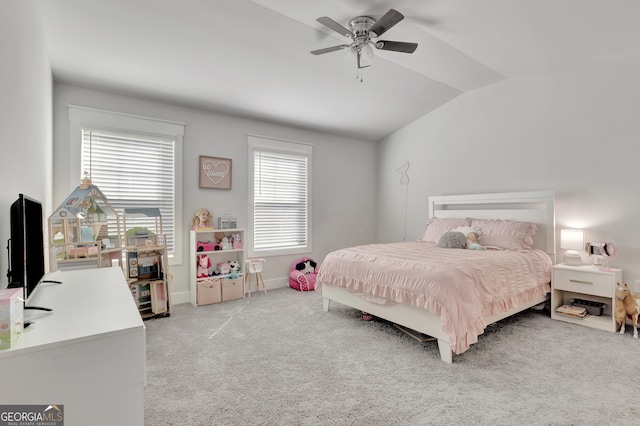 carpeted bedroom featuring a ceiling fan, vaulted ceiling, and baseboards