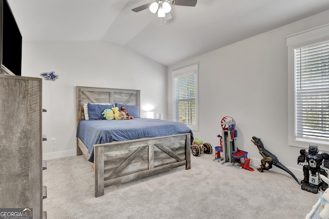 bedroom with ceiling fan, baseboards, vaulted ceiling, and light colored carpet