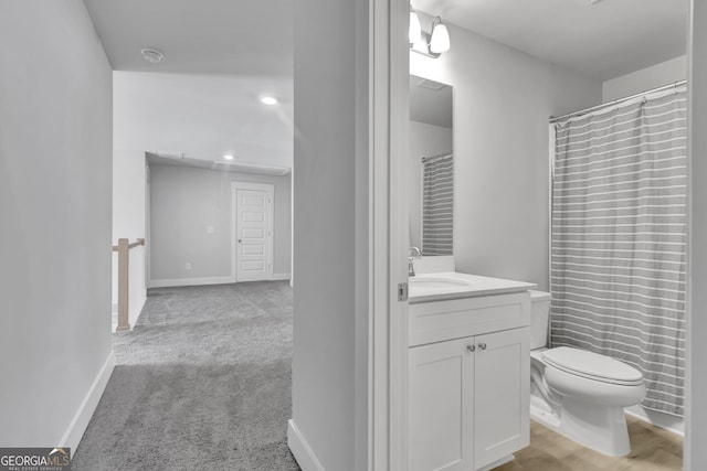 full bathroom featuring toilet, vanity, and baseboards