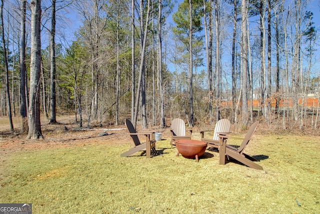 view of yard with a fire pit