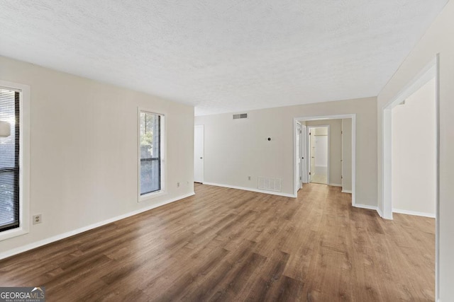 601 Park Ridge Cir, Marietta, GA 30068 - unfurnished living room with wood finished floors and a textured ceiling