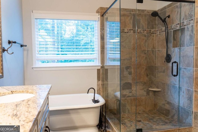 full bath with a soaking tub, a shower stall, and vanity