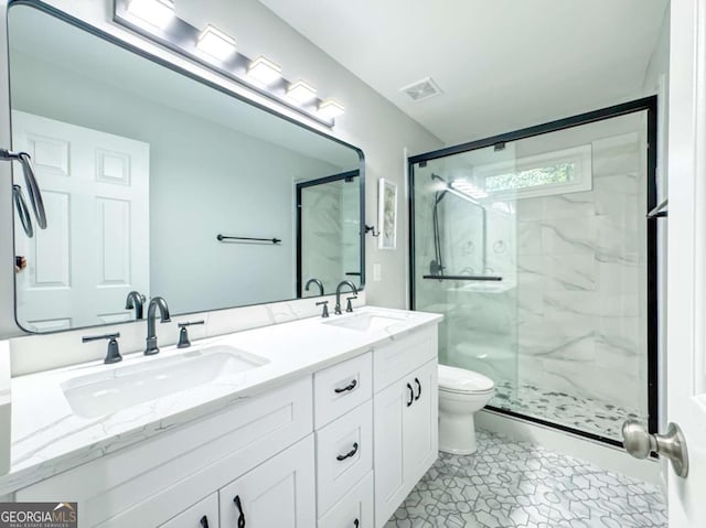 full bath with toilet, visible vents, a sink, and a marble finish shower