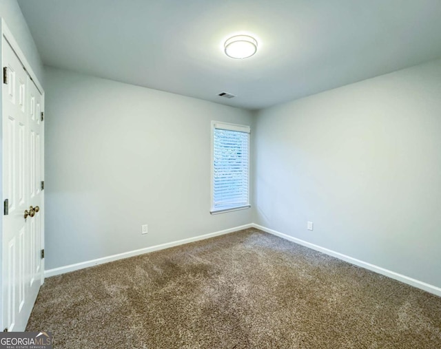 unfurnished bedroom with baseboards, a closet, visible vents, and carpet flooring