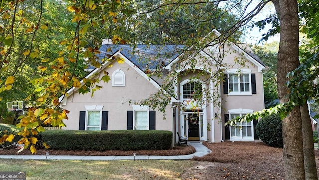 traditional-style home featuring stucco siding