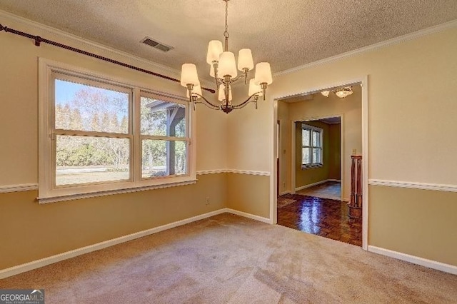 unfurnished dining area with carpet, visible vents, ornamental molding, a textured ceiling, and a chandelier