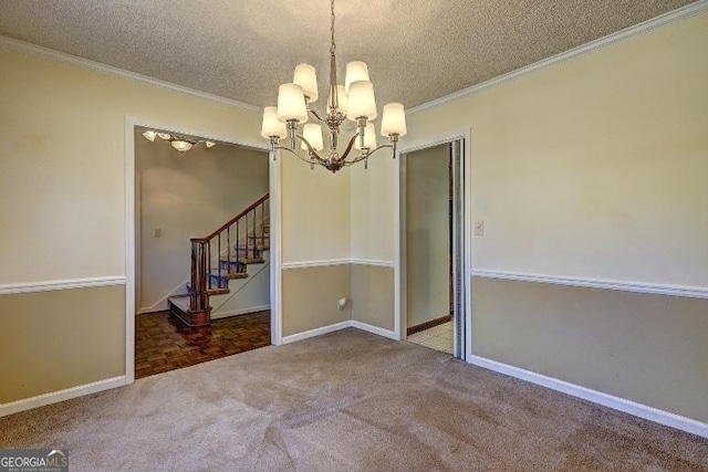 empty room featuring a textured ceiling, carpet floors, a notable chandelier, and crown molding