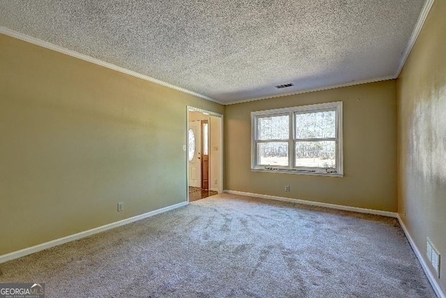 carpeted spare room featuring visible vents, a textured ceiling, baseboards, and crown molding