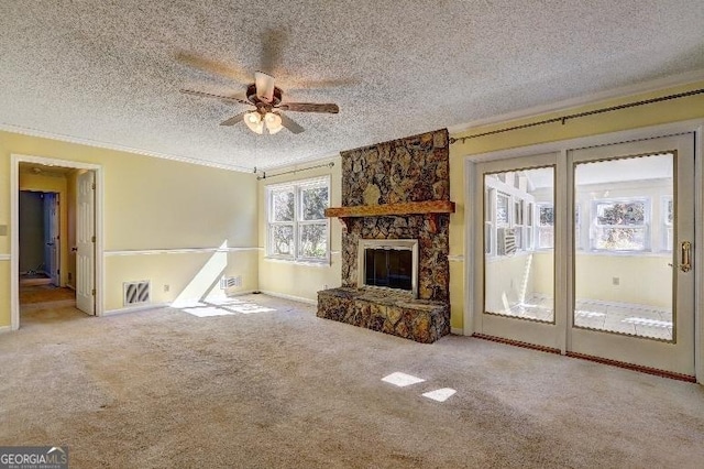 unfurnished living room with ornamental molding, light colored carpet, visible vents, and a textured ceiling