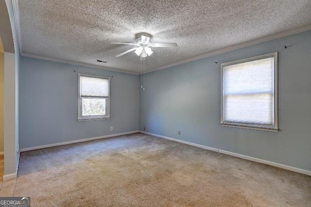 unfurnished room with a textured ceiling, baseboards, crown molding, and light colored carpet