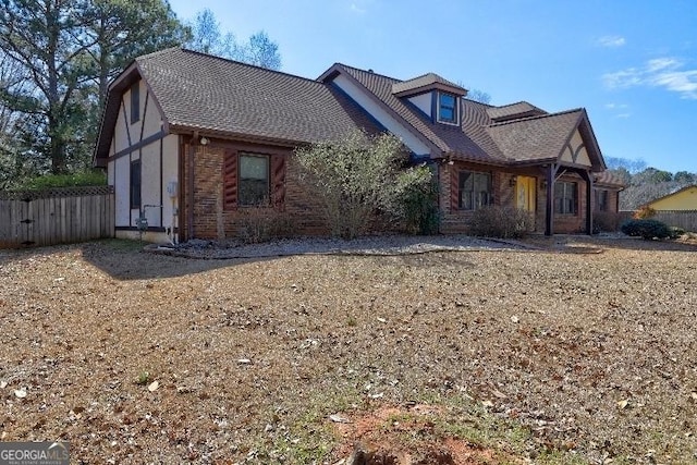 view of front of home featuring a garage and fence