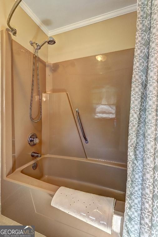 full bathroom featuring crown molding and shower / bathtub combination with curtain