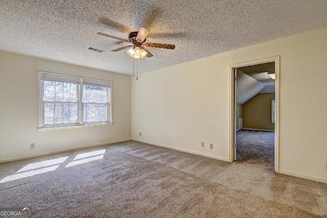 spare room featuring a textured ceiling, baseboards, visible vents, and light colored carpet