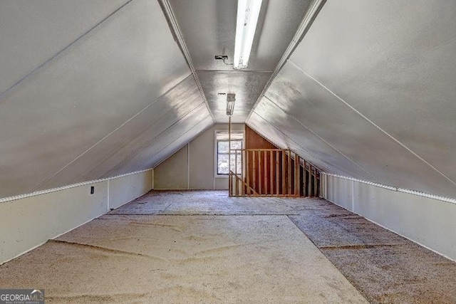 bonus room featuring vaulted ceiling and carpet