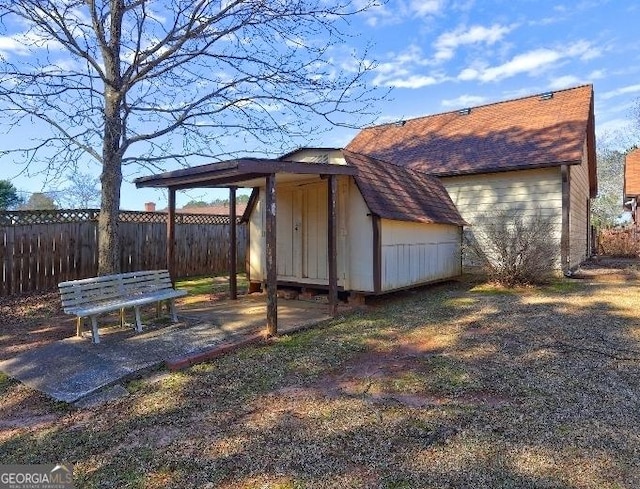 view of shed featuring fence