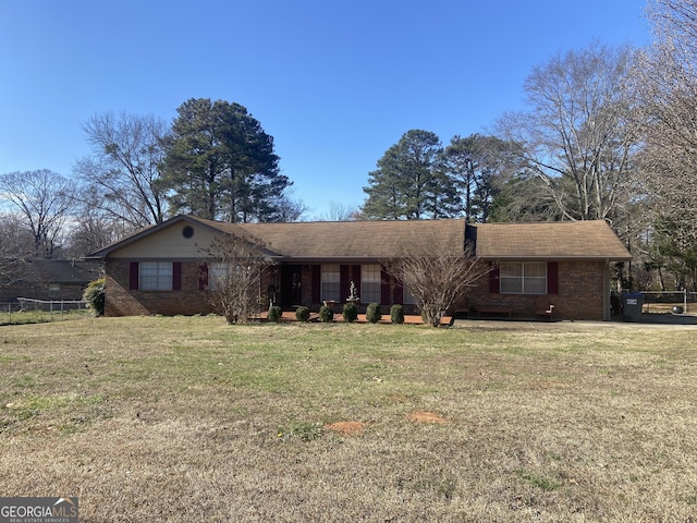 ranch-style home with a front yard and brick siding