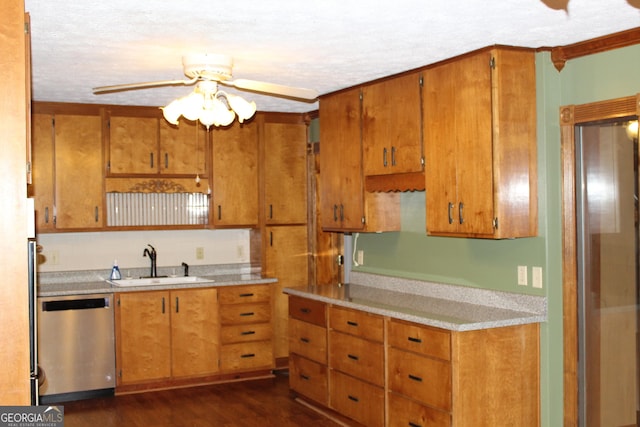 kitchen with brown cabinetry, light countertops, dishwasher, and a sink