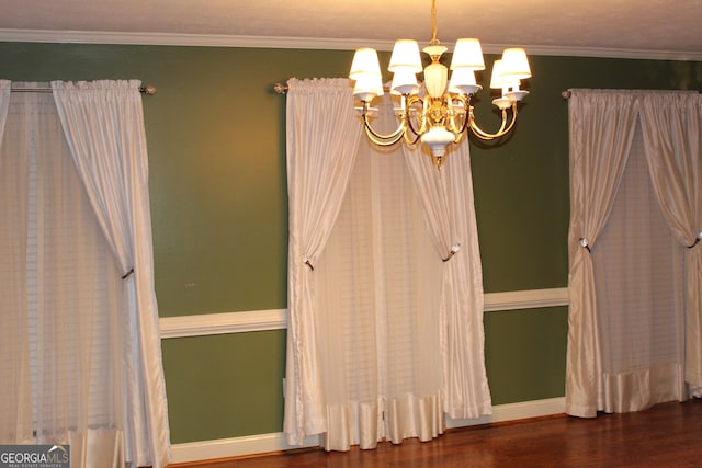 interior space featuring a chandelier, dark wood finished floors, baseboards, and ornamental molding