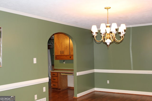 unfurnished dining area with baseboards, arched walkways, dark wood-style flooring, an inviting chandelier, and crown molding