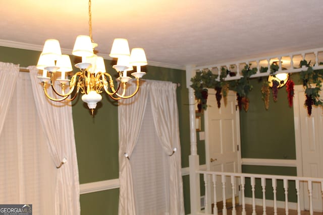 interior space featuring ornamental molding and a chandelier