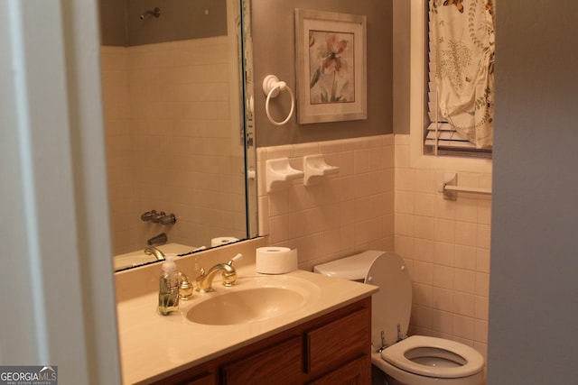 full bathroom featuring toilet, tile walls, and vanity