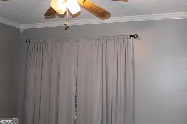 interior details featuring ceiling fan, a textured ceiling, and crown molding