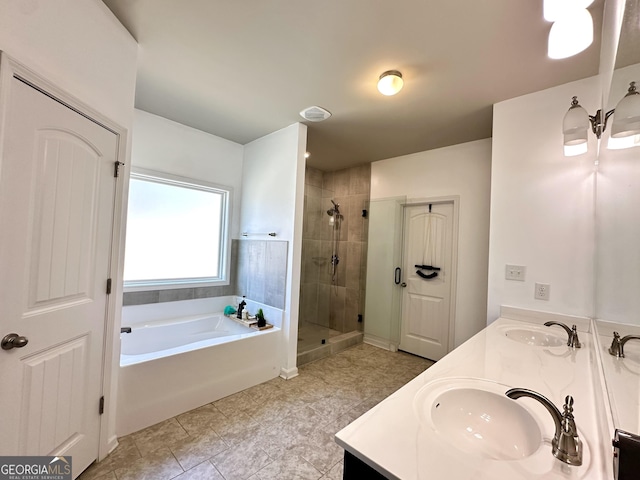 bathroom with double vanity, a sink, and a bath